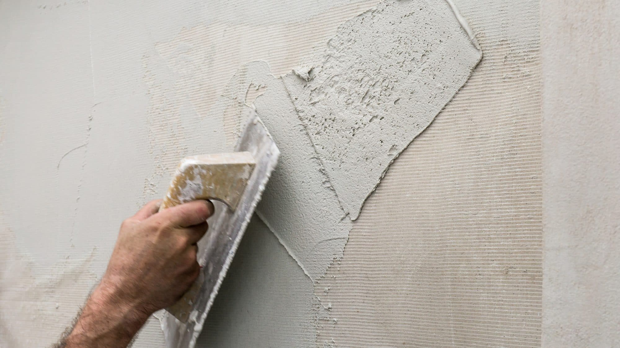 Artisan hand-applying a polished plaster finish